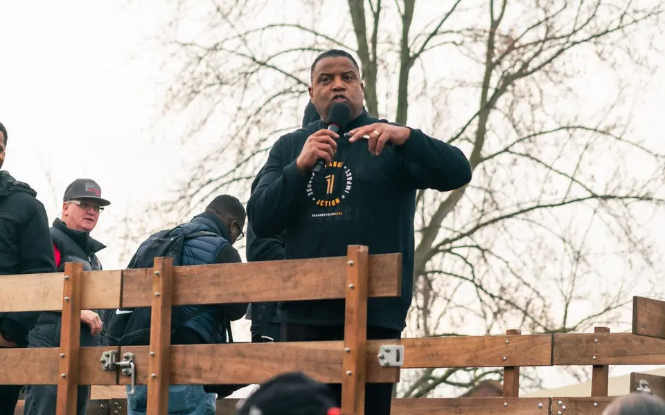 A march leader speaks to the crowd before stepping off
