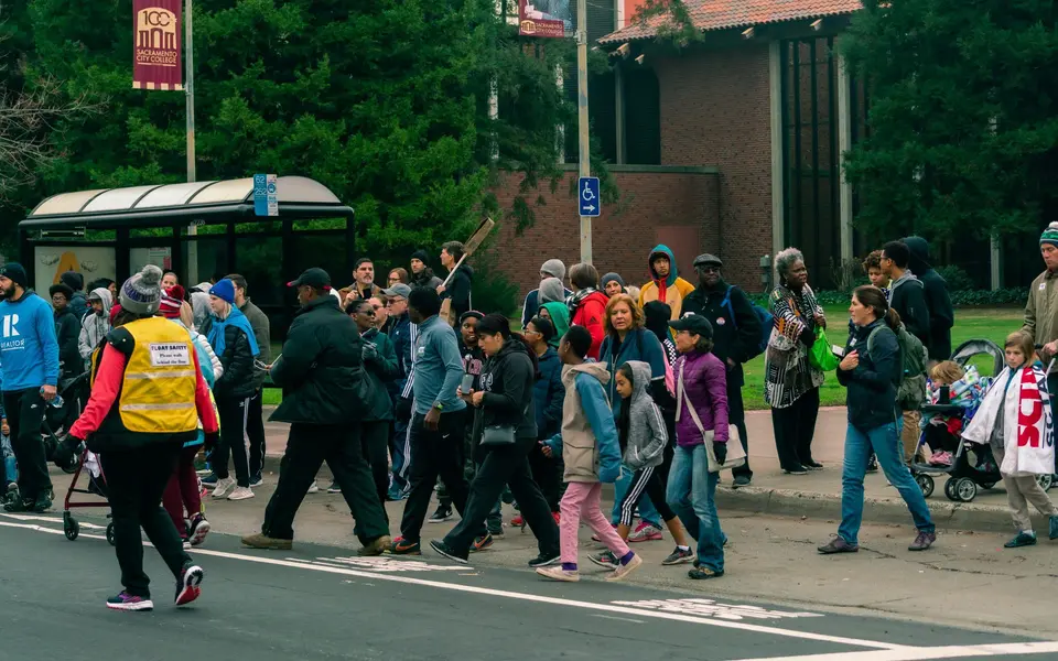Marchers cross the street together