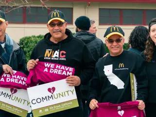 Marchers smile and hold up "We have a dream" and "Community" signs