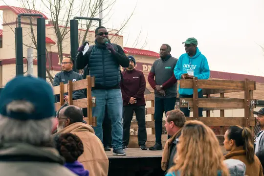 Speakers address the crowd from the stage before step-off