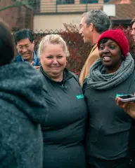 Women share a laugh in the crowd