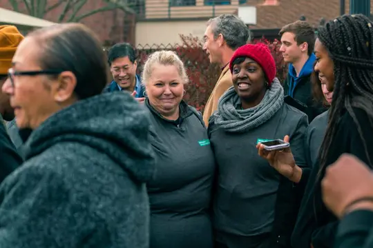 Women share a laugh in the crowd