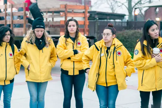 Volunteers in yellow jackets wait to welcome marchers in the morning