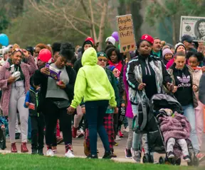 Families with strollers march together