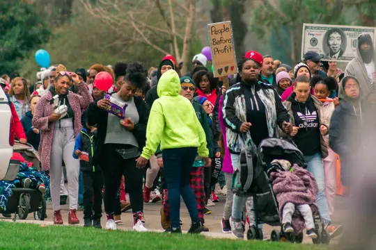 Families with strollers march together