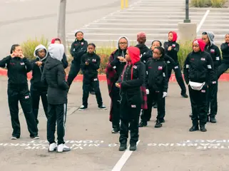 A youth drill team lines up before stepping off