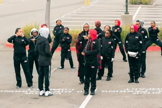 A youth drill team lines up before stepping off